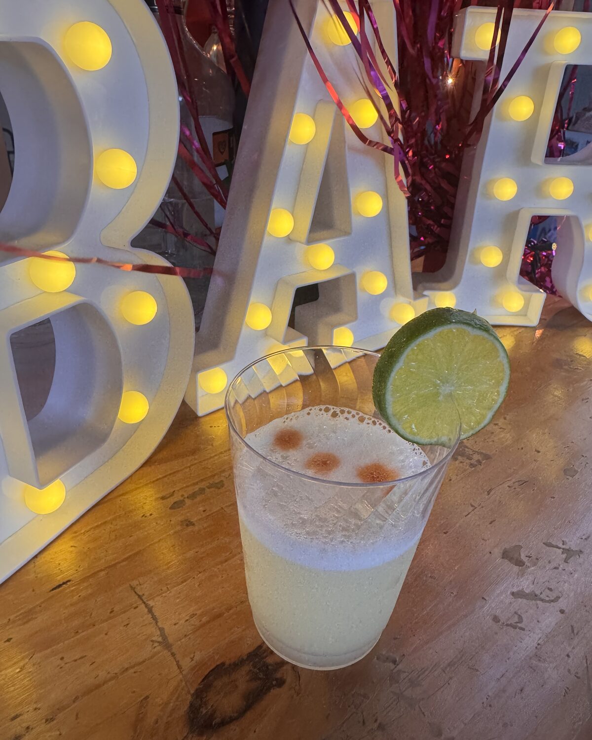 Cart N Craft mobile bar with a lit BAR marquee sign and a fresh margarita